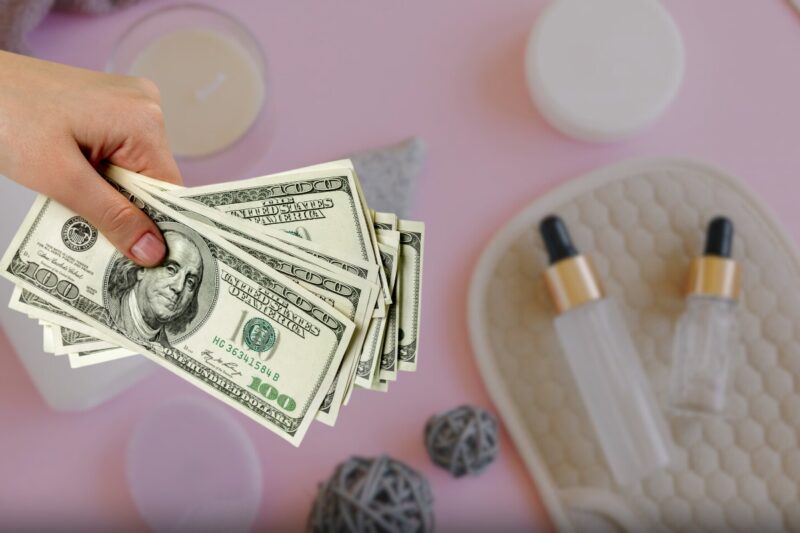 beauty products and hands holding money 