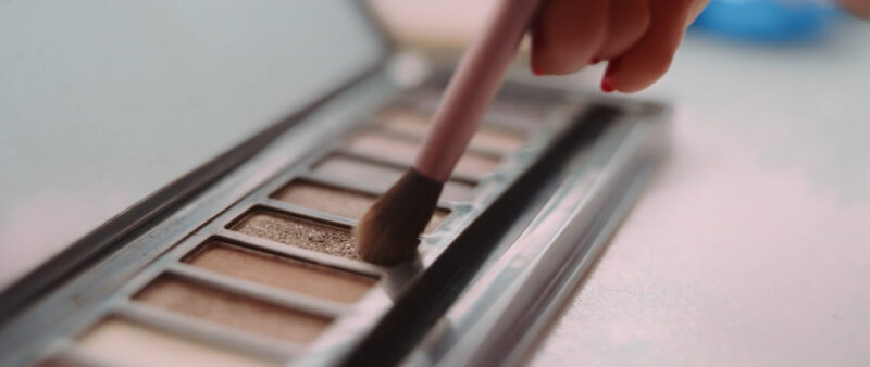 Woman applying eyeshadow with a brush