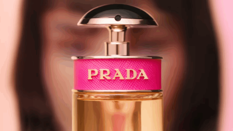 Close-up of the Prada Candy perfume bottle with a pink label and gold lettering