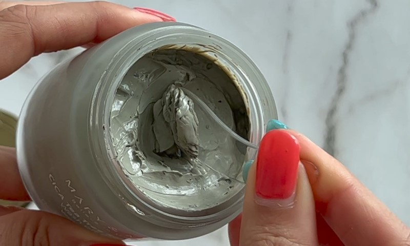 A person holds a jar of Centella asiatica product