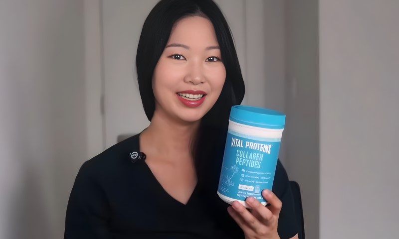 A woman holding a blue container of a collagen