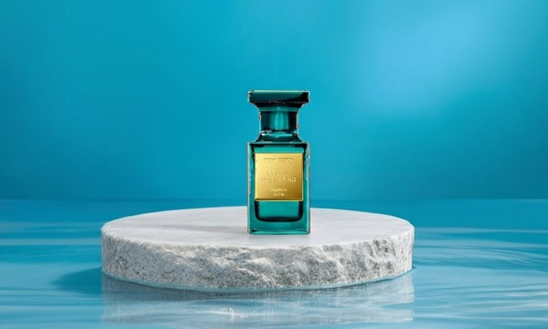 Neroli Portofino Eau de Parfum fragrance bottle on a white marble pedestal against a bright blue background