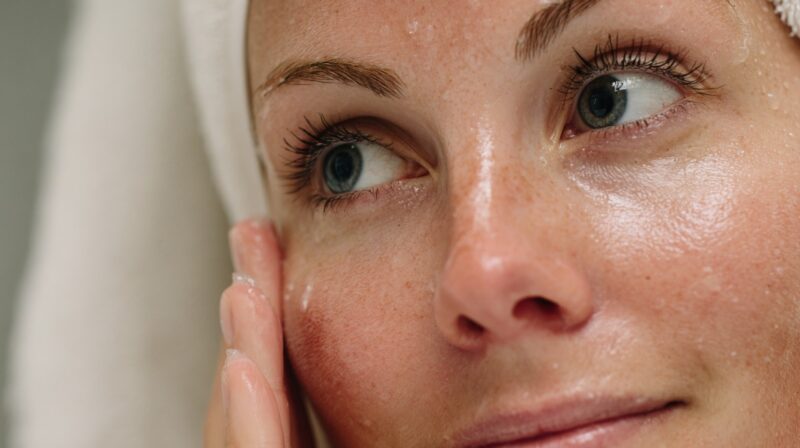 Close up of a woman’s face with clean, dewy skin after skincare application