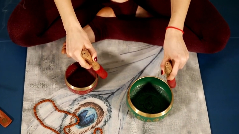 Hands playing singing bowls during one of the unusual wellness therapies