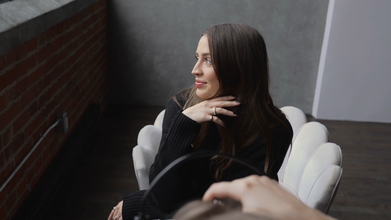 Woman posing naturally with relaxed expression during a portrait photo session