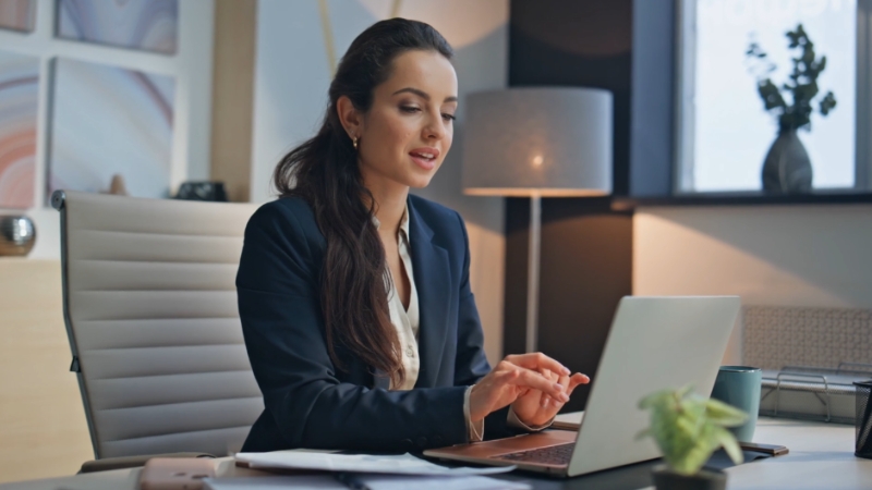 Woman working at a laptop after returning to work following laparoscopic ovarian cyst surgery