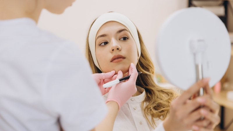 Dermatology specialist examining a patient’s facial skin during a professional consultation