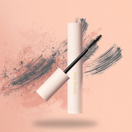 Neutral-toned mascara tube and wand with a fluffy brush designed for volume and definition