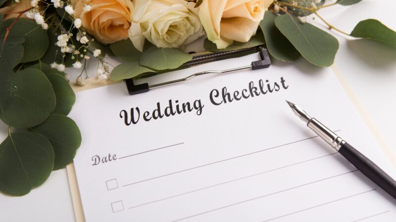 Wedding checklist with flowers and a pen ready for final planning notes